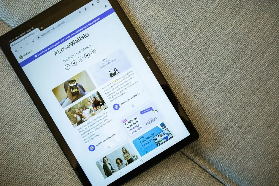 Hands typing on a laptop with cryptocurrency charts and smartphone display in view, focusing on digital finance.